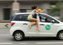 mulher pula de carro em movimento